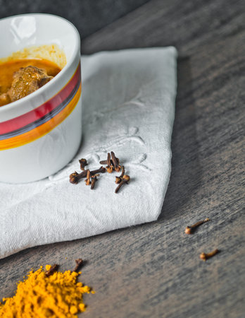 traditional cup of tasty soup, hot and steaming with beef, vegetables, curry, turmeric and clove...