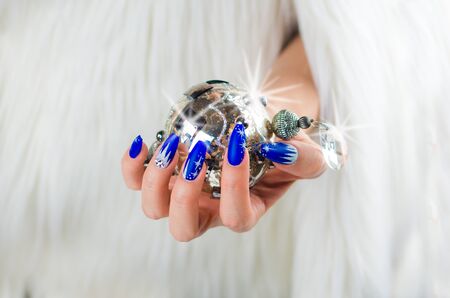 nails decorated with blue color and bright stars to celebrate Christmas and the last of the yearの写真素材