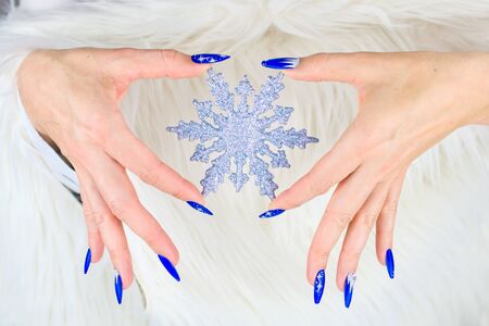 nails decorated with blue color and bright stars to celebrate Christmas and the last of the yearの写真素材