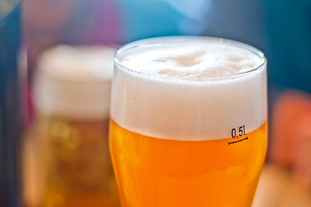 glass half-liter of fresh frothy beerの写真素材