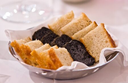 basket with white bread and black breadの写真素材