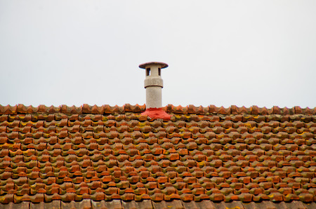 roof vent stopped with cement on the roof with red brick roofの写真素材