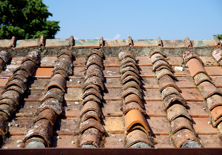 roof with old and broken tiles replaced with new tilesの写真素材