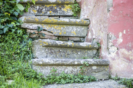 stone steps worn by the passage of millions of feet in an ancient house in the historic medieval villageの写真素材