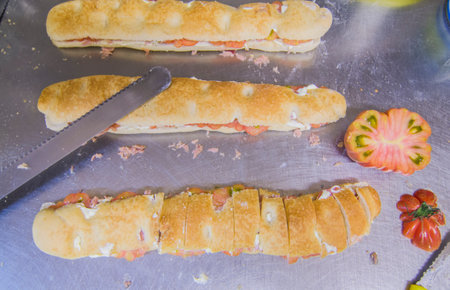 delicious snack, focaccia with tomato, egg, mayonnaise, vegetables and tunaの写真素材