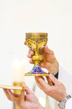 in the church wine becomes the blood of christ, and the host becomes the body of christの写真素材