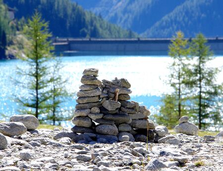 stone pyramids, little man, mound, ovoo, Inukshuk built for your calm and tranquility made near the lake or the mountain riverの写真素材
