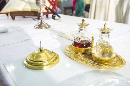 church altar with small wine vial ready to become the blood of jesus christ during the massの写真素材