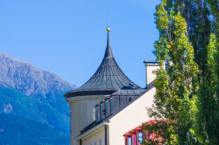 church with onion bell tower in the mountains in the Gothic style with fragrant flowers under the...