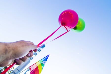 seller holds colorful balloons ready for childrenの写真素材