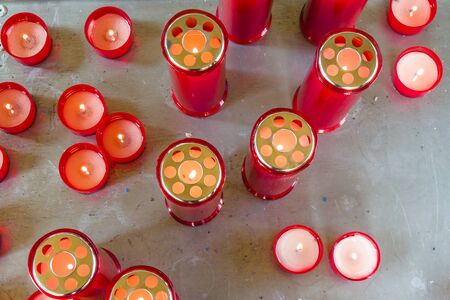 red candles that in the dark remind us of the deceased people we lovedの写真素材