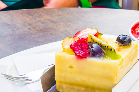 cake, passion fruit semifreddo cube with strawberry, kiwi, grapes, plum, blackberry and cape...