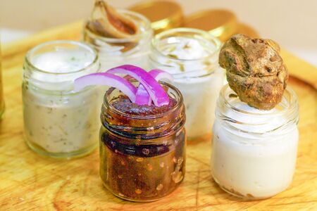 Italian appetizers, truffle butter, anchovy butter, aromatic herb butter, artichokes in oil, pickled cucumbers, sweet and sour onions, onion jam.の写真素材