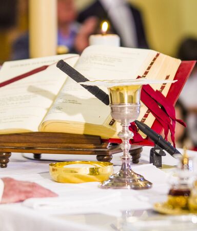 altar with host that becomes the body of jesus christ and chalice for wine, blood of christ, with the book for the mass of the faithfulの写真素材