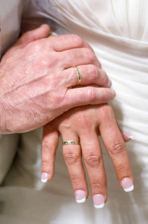 fingers of the young spouses play touch the rings of love that they have given themselves for a lifetimeの写真素材