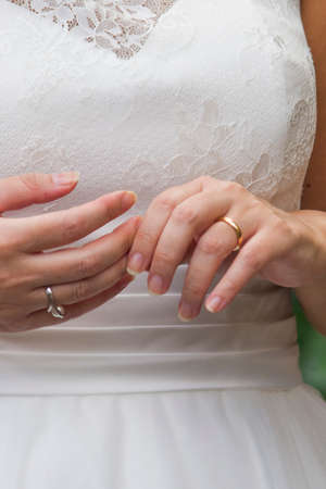 fingers of the young spouses play touch the rings of love that they have given themselves for a lifetimeの写真素材
