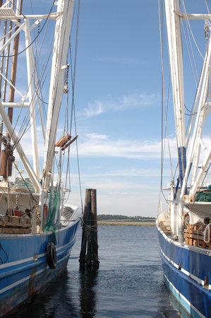 Two shrimp boats sitting in the harbor