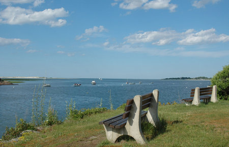 Benches overlooking the Essex River, Essex, MA, on a clear summer day