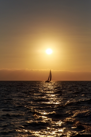 Sailboat against a beautiful sunsetの写真素材
