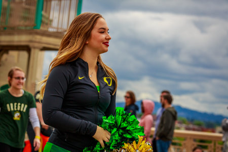 Portland, Oregon, USA - June 8, 2019: University or Oregon cheerleaders in the Grand Floral Parade,...