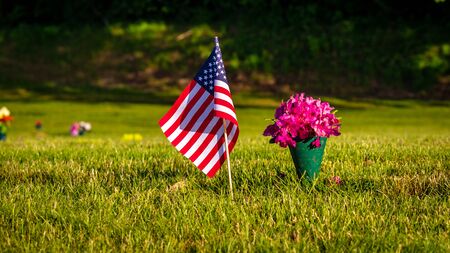 US Flags and Flowers presented at local cemetery on Memorial Dayの写真素材