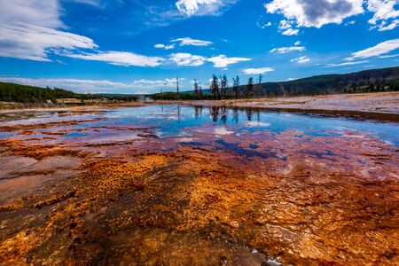 Strange ground surface in red, brown, orange colors, in Biscuit Basin, Yellowstone National Parkの写真素材