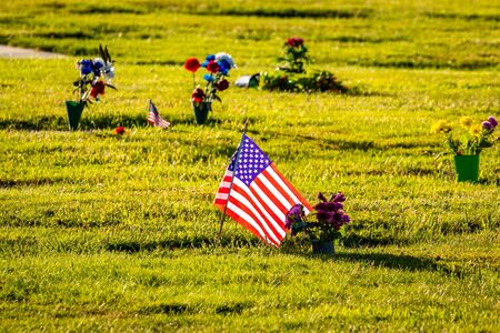 US Flags and Flowers presented at local cemetery on Memorial Dayの写真素材