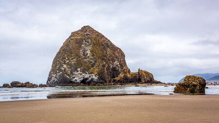 Haystack Rock at low tide, Cannon Beach, Oregonの写真素材