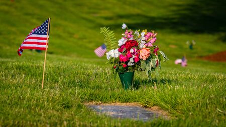 US Flags and Flowers presented at local cemetery on Memorial Dayの写真素材