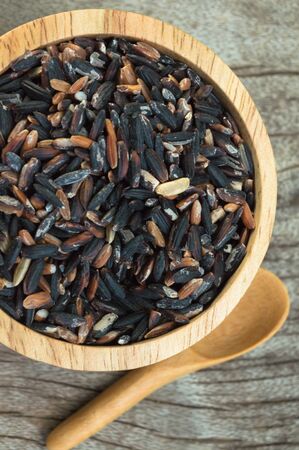 rice in a cup on wood backgroundの写真素材