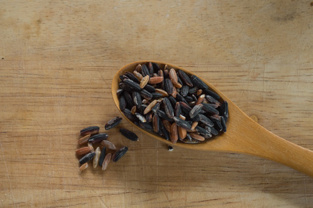 rice in a cup on wood backgroundの写真素材