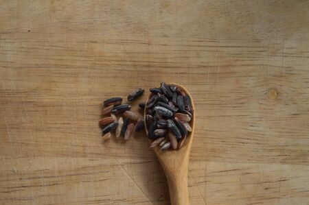 rice in a cup on wood backgroundの写真素材