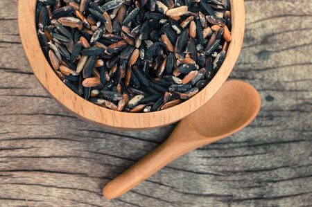 rice in a cup on wood backgroundの写真素材