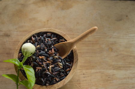 rice in a cup on wood backgroundの写真素材