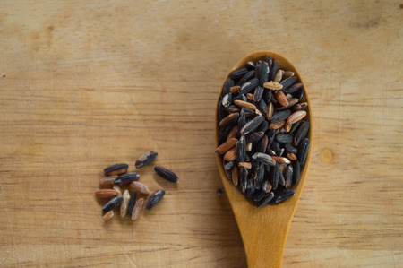 rice in a cup on wood backgroundの写真素材