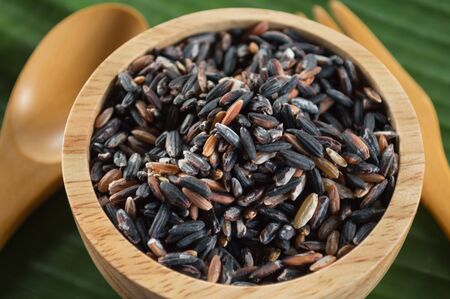 rice in a cup on wood backgroundの写真素材