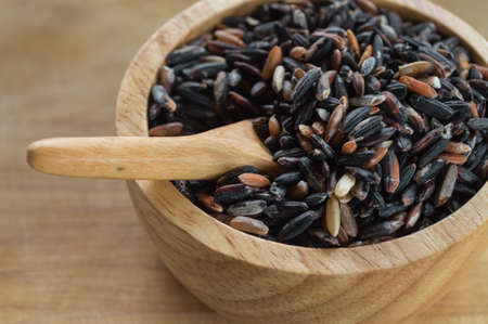 rice in a cup on wood backgroundの写真素材