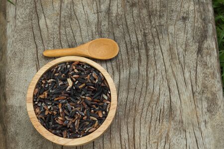 rice in a cup on wood backgroundの写真素材