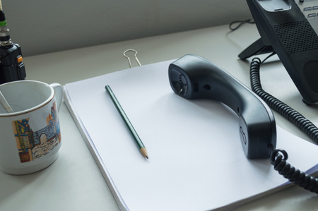 business office telephone and coffee in morningの写真素材