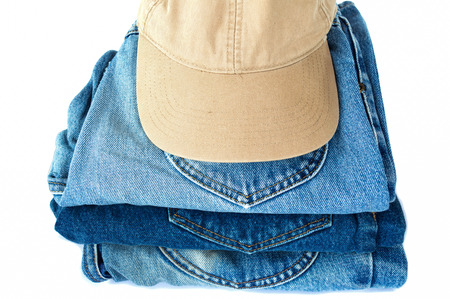 stack of blue jeans on white backgroundの写真素材
