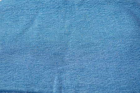 stack of blue jeans on white backgroundの写真素材