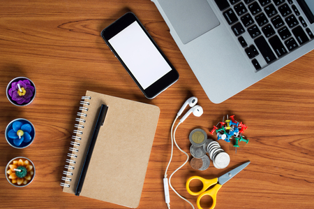 Office table with notepad, laptop and coffee cup.View from above with copy space.の写真素材