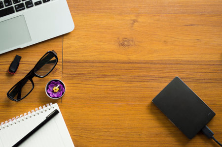 Office table with notepad, laptop and coffee cup.View from above with copy space.の写真素材