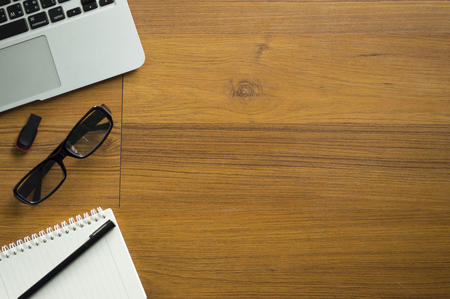 Office table with notepad, laptop and coffee cup.View from above with copy space.の写真素材