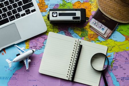 Go on an adventure! The map and the passport on a wooden table. Top view Travel concept.の写真素材