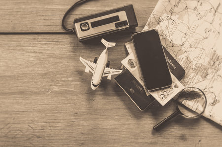 Go on an adventure! The map and the passport on a wooden table. Top view Travel concept.