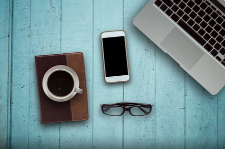 Office desk wood with computer, note book,phone and coffee cup concept in wood background.Copy spaceの写真素材