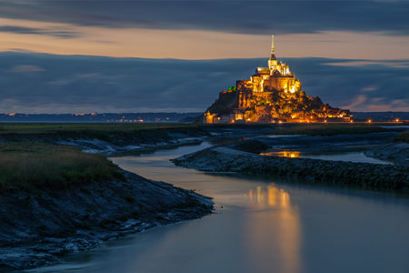 Normandy, France. The illuminated Mont Saint Michel is reflected on the water
