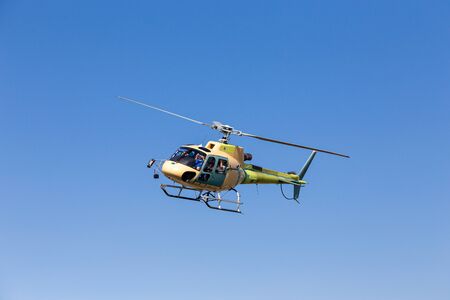 A helicopter in flight on a sunny day. The helicopter has not yet been painted permanently.の写真素材