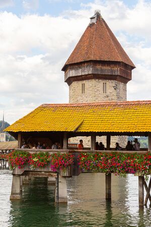 LUCERNE, SWITZERLAND - AUGUST 22, 2014: Famous Chapel Bridge in the historic city center of Lucerne, the citys symbol and one of Switzerlands main tourist attractions.のeditorial素材